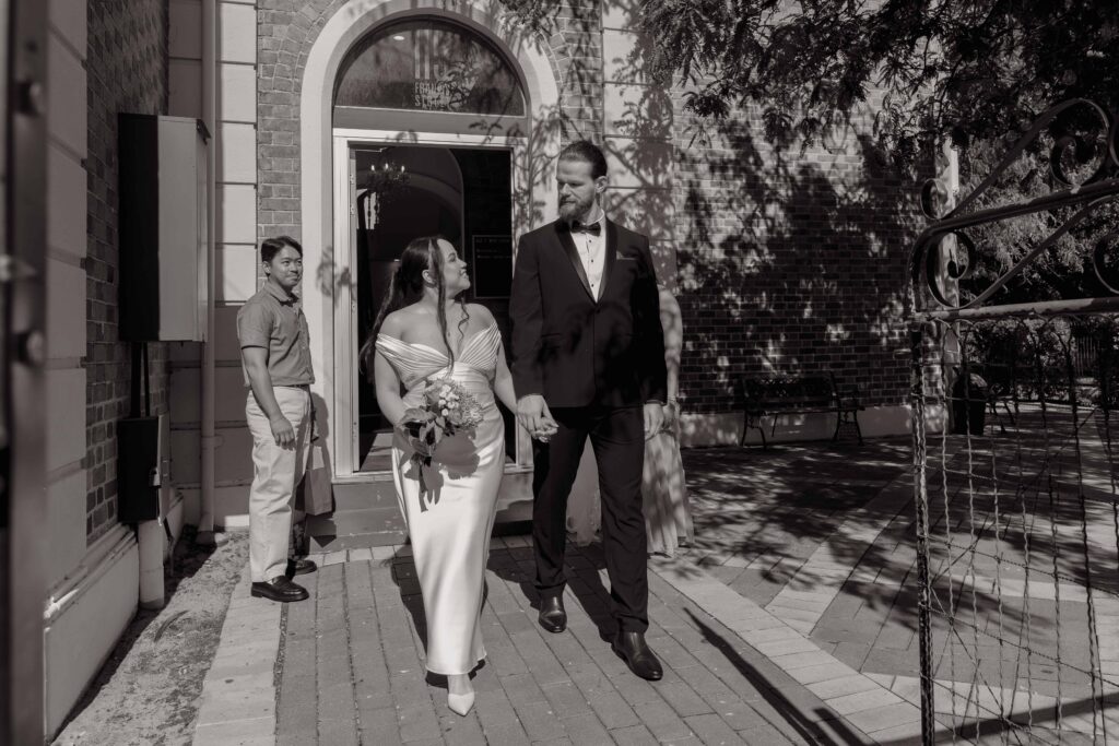Couple holding hands at their intimate Old Tower House wedding in Perth.